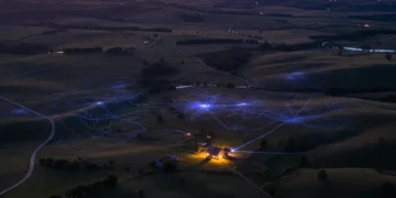 Rural landscape with digital network overlay representing internet access challenges.